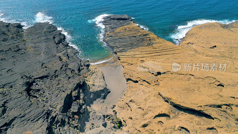 Aerial view of the hidden cove beach "Playa Cumplida" at the natural reserve of "Montaña Pelada" in Tenerife (Canary Islands). Drone shot